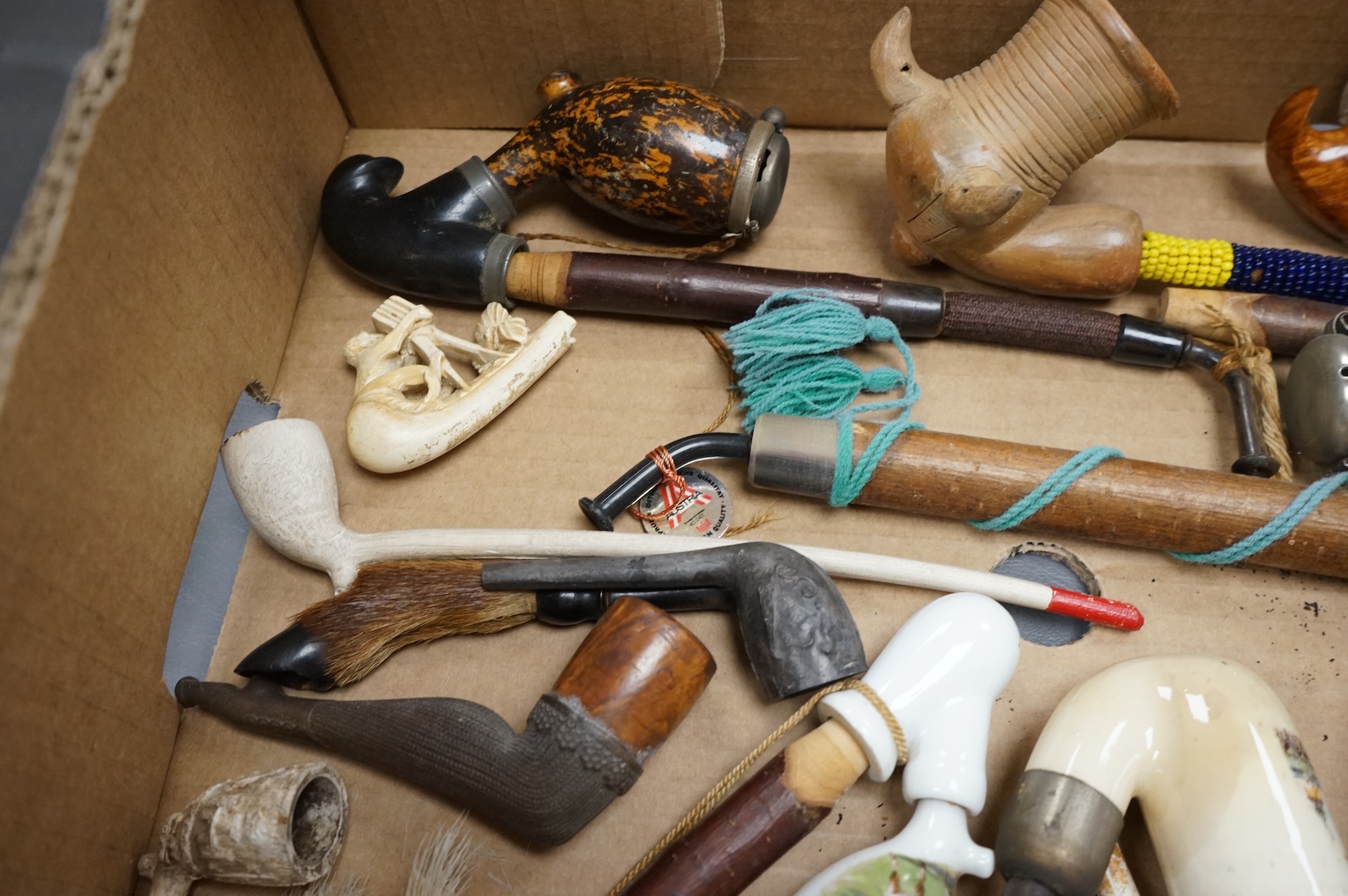 A group of fifteen novelty pipes to include treen, clay and ceramic examples